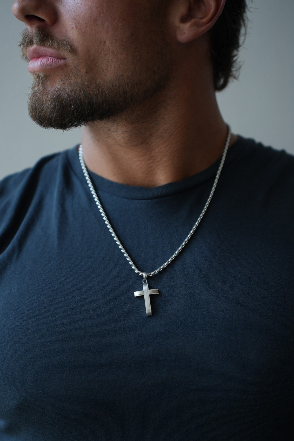 Close-up of the Apex Silver Cross Necklace pendant and chain