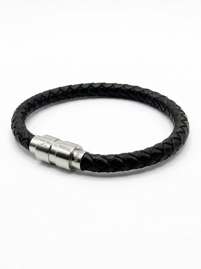 Ethos Black Leather Bracelet in braided leather, laid in a circle on a white background with its brushed steel magnetic clasp