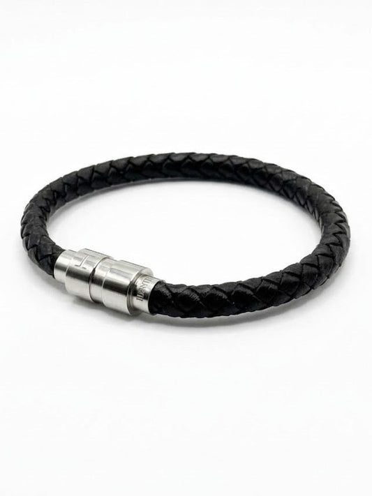 Ethos Black Leather Bracelet in braided leather, laid in a circle on a white background with its brushed steel magnetic clasp