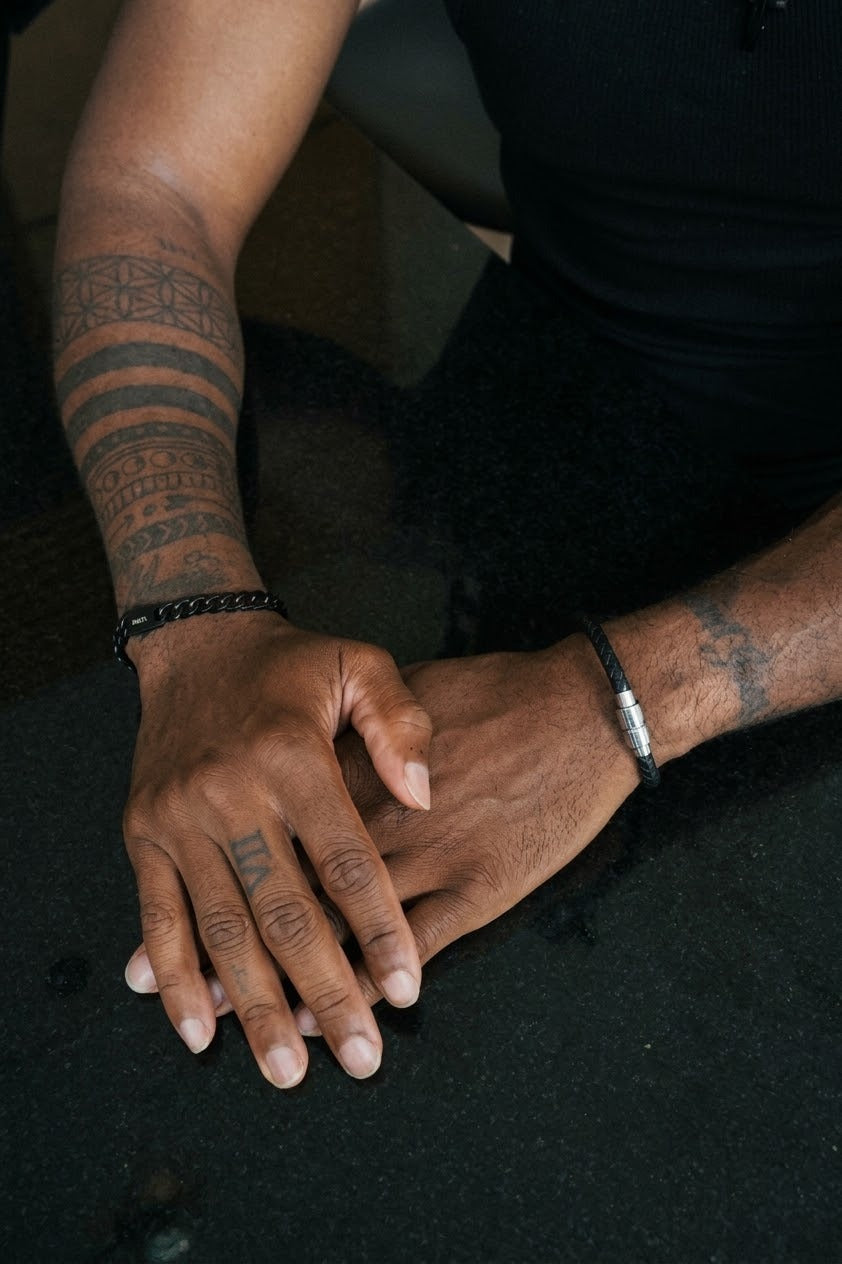 Ethos Black Leather Bracelet worn on the wrist, with the Foundation black link bracelet