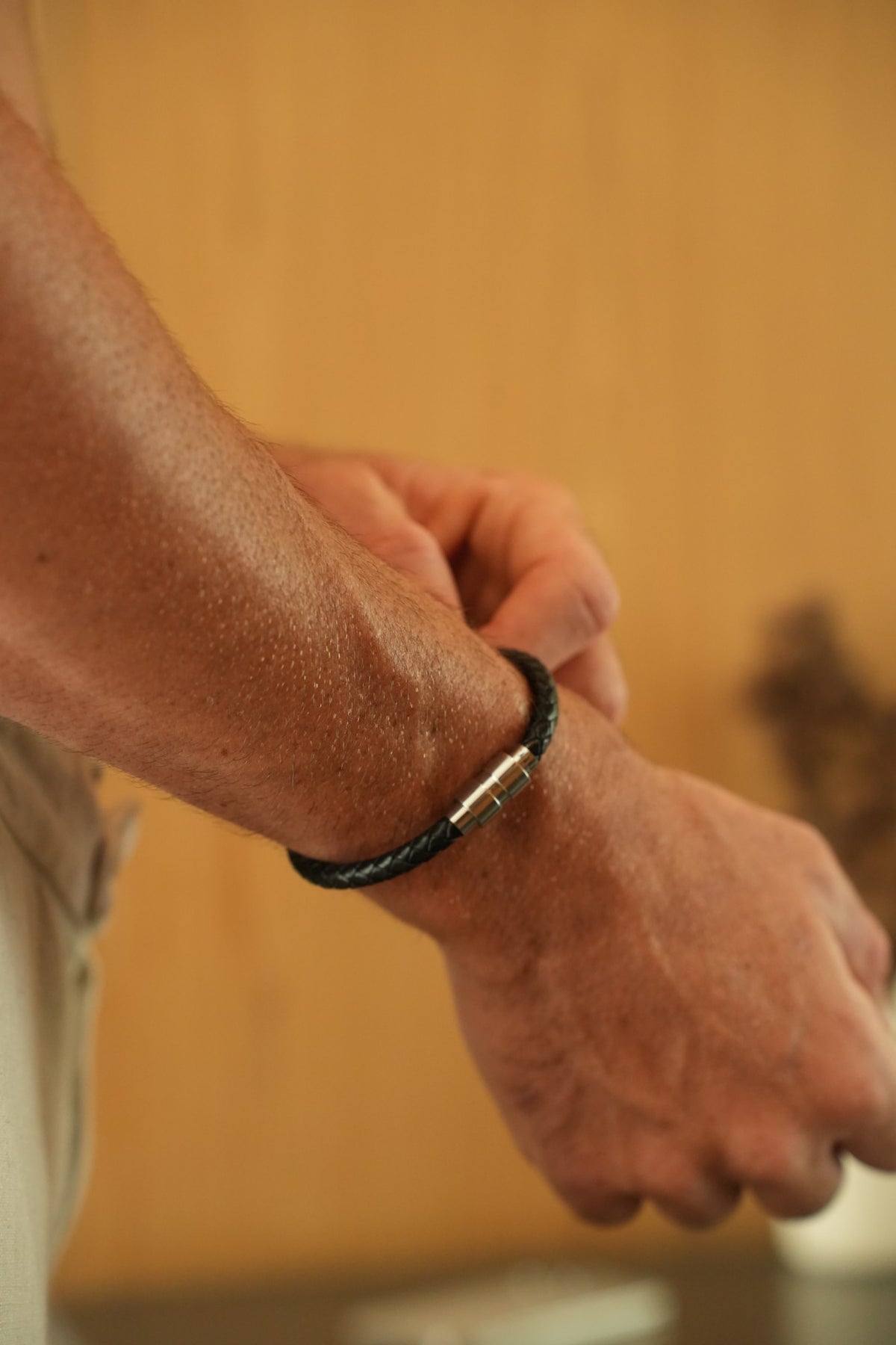 Ethos Black Leather Bracelet on the wrist, steel magnetic clasp in view