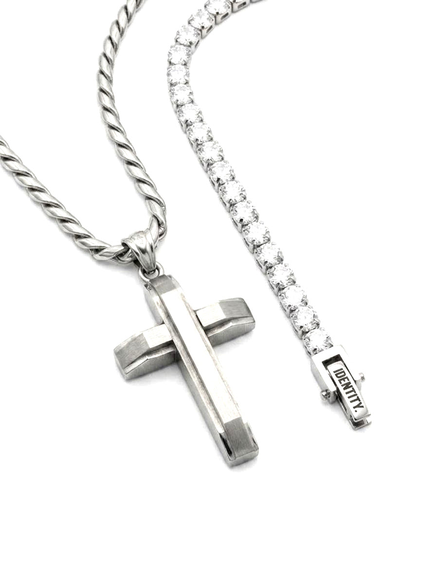 Cross pendant beside the Clarity tennis bracelet