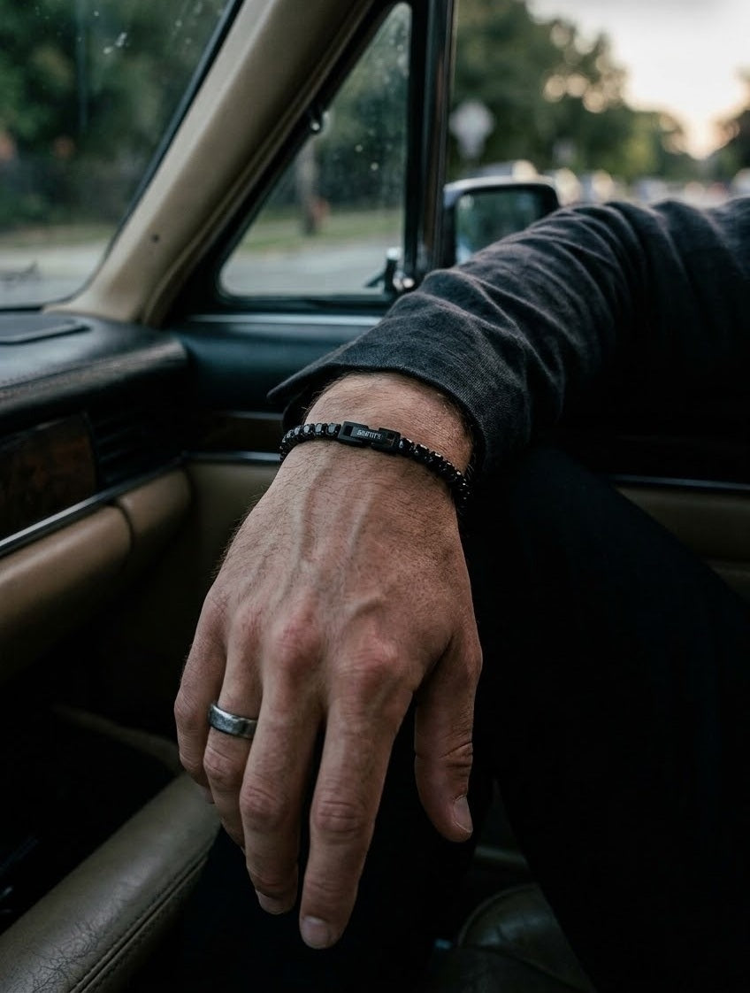 Origin Black Tennis Bracelet worn on the wrist, resting on a car door at dusk
